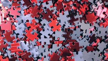 Background of Colored Puzzle Pieces that Slowly Rotating Clockwise - Top View. Texture of Incomplete Red and Grey Jigsaw Puzzle - Right Rotation video