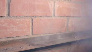 The Petard Was Placed on a Metal Surface by the Hand Than Explode Against a Brick Wall. Many Small Particles Flew in a Different Directions - Static Shot video