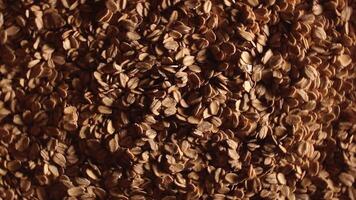 Oat Flakes Background Rotating Left - Top View, Low Key Light. Scattered Dry Oat Flakes. Healthy Breakfast and Diet Eating Ingredients video