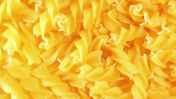 Uncooked Fusilli Pasta with Spiral Form - Rotating Background, Top View. Golden Raw and Dry Fusilli Macaroni Texture Rotate. Italian Culture and Cuisine video