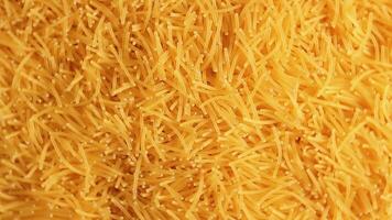Background of Uncooked Noodles that Rotating Clockwise - Top View, Close-Up. Texture of Dry Vermicelli Turning Around. Raw Pasta - Right Rotation video