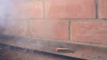 The Petard Was Placed on a Metal Surface by the Hand Than Explode Against a Brick Wall. Many Small Particles Flew in a Different Directions - Static Shot video