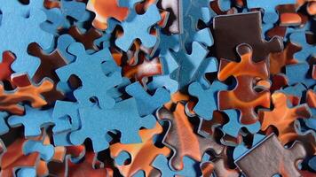 Background of Colored Puzzle Pieces that Slowly Rotating Clockwise - Top View, Close-Up. Texture of Incomplete Red and Blue Jigsaw Puzzle - Right Rotation video