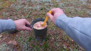 Camp Food. Cooking in a Forest Using a Small Cook Set - First Person View, Wide Angle. Food on the Trip. Traveler in a Forest. Tourist in a Travel is Heating Food - POV Shot video