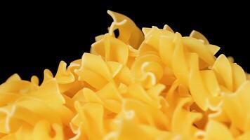 Uncooked Fusilli Pasta Heap Rotating against Black Background. Fat and Unhealthy Food. Dry Spiral Macaroni. Italian Culture and Cuisine. Raw Golden Pasta video