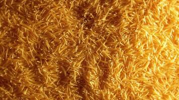Background of Uncooked Golden Noodles that Rotating Clockwise - Top View. Texture of Dry Vermicelli Turning Around. Raw Pasta with Low Key Light - Right Rotation video