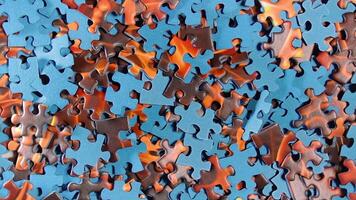 Background of Colored Puzzle Pieces that Slowly Rotating Counterclockwise - Top View. Texture of Incomplete Red and Blue Jigsaw Puzzle - Left Rotation video