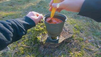 Camp Food. Cooking in a Hike Using a Small Cook Set - First Person View, Wide Angle. Food on the Trip. Traveler in a Spring Forest. Tourist in a Travel is Heating Food - POV Shot. video