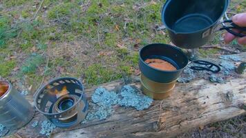 Camp Food. Cooking in a Hike Using a Small Cook Set - First Person View, Wide Angle. Food on the Trip. Traveler in a Spring Forest. Tourist in a Travel is Heating Food - POV Shot. video