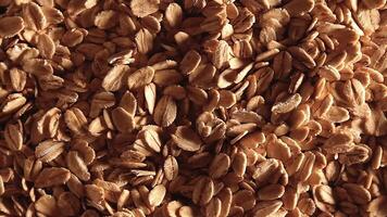 Oat Flakes Background Slowly Rotating Left - Top View, Low Key Light. Scattered Dry Oat Flakes. Healthy Breakfast and Diet Eating Ingredients video