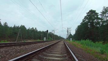 Moving Forward Along the Railroad Going Through the Pine Forest. European Railway for Electric Train - Smooth Movement on Gimbal Stabilizer video
