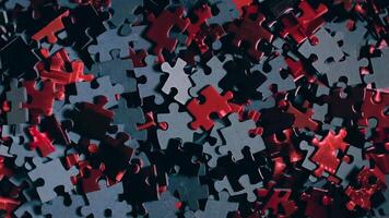 Background of Colored Puzzle Pieces that Slowly Rotating Counterclockwise - Top View. Texture of Incomplete Red and Grey Jigsaw Puzzle with Low Key Light - Left Rotation video
