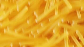 Background of Uncooked Noodles Moving Down - Top View, Close-Up. Raw Pasta in Move. Texture of Dry Vermicelli video