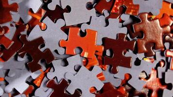 Background of Colored Puzzle Pieces that Rotating Clockwise - Top View, Close-Up. Texture of Incomplete Red and Grey Jigsaw Puzzle - Right Rotation video