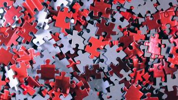Background of Colored Puzzle Pieces that Slowly Rotating Counterclockwise - Top View. Texture of Incomplete Red and Grey Jigsaw Puzzle - Left Rotation video