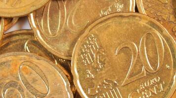 Scattered 20 Euro Cent Coins, Rotating Money Background - Top View, Macro. Euro Money Currency. A Lot of Twenty Cent Cash. Business, Finances and Money Saving Concept - Slow Rotation Right video