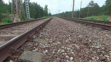 Moving Forward Along the Railroad Going Through the Pine Forest. European Railway for Electric Train - Smooth Movement on Gimbal Stabilizer video