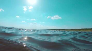 Over and Under Sea Surface with the Lights of the Sun Through the Water. Underwater Split View with Sea Waves at Sunny Summer Day - Slow Motion video