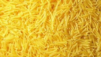 Background of Uncooked Noodles that Slowly Rotating Counter-Clockwise - Top View, Angular Rotation. Texture of Dry Vermicelli Turning Around. Raw Pasta - Left Rotation video