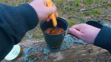Camp Food. Cooking in a Hike Using a Small Cook Set - First Person View, Wide Angle. Food on the Trip. Traveler in a Spring Forest. Tourist in a Travel is Heating Food - POV Shot. video