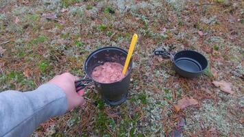Camp Food. Cooking in a Forest Using a Small Cook Set - First Person View, Wide Angle. Food on the Trip. Traveler in a Forest. Tourist in a Travel is Heating Food - POV Shot video