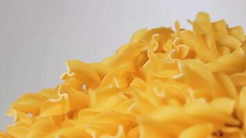 Uncooked Fusilli Pasta Heap Rotating against White Background. Fat and Unhealthy Food. Dry Spiral Macaroni. Italian Culture and Cuisine. Raw Golden Pasta video