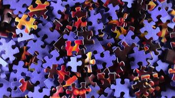 Background of Colored Puzzle Pieces that Rotating Counterclockwise - Top View. Texture of Incomplete Red and Blue Jigsaw Puzzle - Left Rotation video