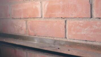 The Petard Was Placed on a Metal Surface by the Hand Than Explode Against a Brick Wall. Many Small Particles Flew in a Different Directions - Static Shot video
