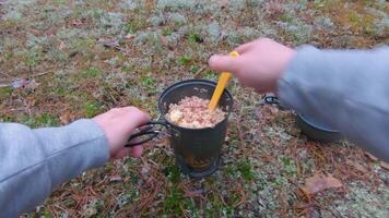 Camp Food. Cooking in a Forest Using a Small Cook Set - First Person View, Wide Angle. Food on the Trip. Traveler in a Forest. Tourist in a Travel is Heating Food - POV Shot video