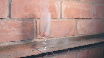 Firecracker Exploaded in a Wineglass Against a Brick Wall. The Blast Wave of a Petard Damaged the Glass and Many Small Fragments of Glass Flew in Different Directions - Static Shot video