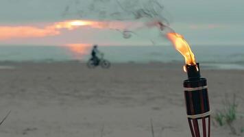 Tropical Bamboo Torch Burning in the Beach at Summer Evening. Decorative Candle Has a Massive Orange Flame Using Oil Fuel or Kerosene - Slow Motion. Static Shot video