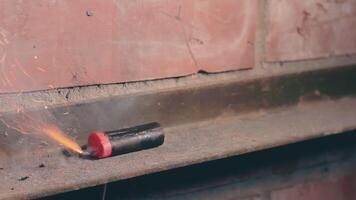 Firecracker Was Lighted Up With a Gas Lighter then Explode Against a Brick Wall. Many Small Particles Flew in a Different Directions - Static Shot video