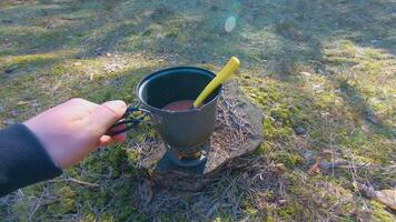 Camp Food. Cooking in a Hike Using a Small Cook Set - First Person View, Wide Angle. Food on the Trip. Traveler in a Spring Forest. Tourist in a Travel is Heating Food - POV Shot. video