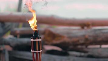 Tropical Bamboo Torch Burning in the Beach at Summer Evening. Decorative Candle Has a Massive Orange Flame Using Oil Fuel or Kerosene. Static Shot video