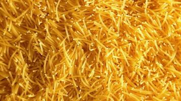 Background of Uncooked Noodles that Slowly Rotating Counterclockwise - Top View, Close-Up. Texture of Dry Vermicelli Turning Around. Raw Pasta with Low Key Light - Left Rotation video