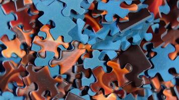 Background of Colored Puzzle Pieces that Rotating Clockwise - Top View, Close-Up. Texture of Incomplete Red and Blue Jigsaw Puzzle - Right Rotation video
