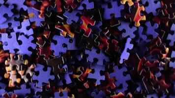 Background of Colored Puzzle Pieces that Rotating Clockwise - Top View. Texture of Incomplete Red and Blue Jigsaw Puzzle with Low Key Light - Right Rotation video