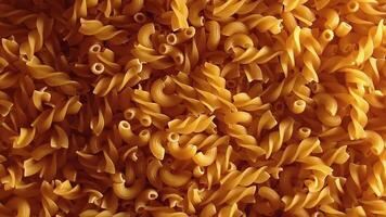 Uncooked Fusilli and Chifferi Rigati Pasta - Top View, Low Key Light. Fat and Unhealthy Food. Classic Dry Macaroni, Slowly Rotating Background. Raw Different Macaroni Pasta Texture - Rotate Right video