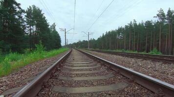 Moving Forward Along the Railroad Going Through the Pine Forest. European Railway for Electric Train - Smooth Movement on Gimbal Stabilizer video