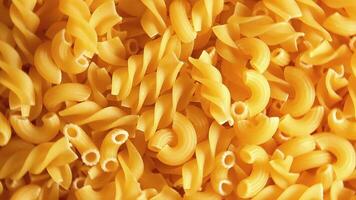 Uncooked Fusilli and Chifferi Rigati Pasta - Top View, Close-Up. Fat and Unhealthy Food. Classic Dry Macaroni, Rotating Background. Raw Different Macaroni Pasta Texture - Rotate Left video
