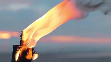 Tropical Bamboo Torch Burning in the Beach at Summer Evening. Decorative Candle Has a Massive Orange Flame Using Oil Fuel or Kerosene - Slow Motion. CloseUp Static Shot video