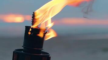 Tropical Bamboo Torch Burning in the Beach at Summer Evening. Decorative Candle Has a Massive Orange Flame Using Oil Fuel or Kerosene - Slow Motion. CloseUp Static Shot video
