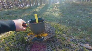 Camp Food. Cooking in a Hike Using a Small Cook Set - First Person View, Wide Angle. Food on the Trip. Traveler in a Spring Forest. Tourist in a Travel is Heating Food - POV Shot. video