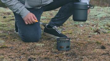 Man in a Forest is Cooking Pasta With Canned Stew Using a Small Cook Set. Tourist in a Hike is Preparing for the Lunch. Close-Up View, Static Shot video