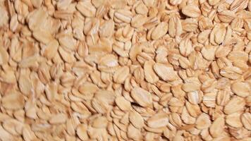 Oat Flakes Background Rotating Clockwise - Top View. Scattered Dry Oat Flakes. Healthy Breakfast and Diet Eating Ingredients - Angular Rotation Right video