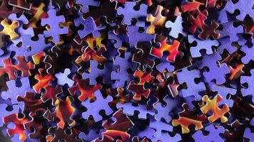 Background of Colored Puzzle Pieces that Slowly Rotating Clockwise - Top View. Texture of Incomplete Red and Blue Jigsaw Puzzle - Right Rotation video