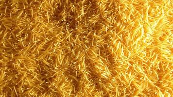 Background of Uncooked Noodles that Slowly Rotating Counterclockwise - Top View. Texture of Dry Vermicelli Turning Around. Raw Pasta with Low Key Light - Left Rotation video