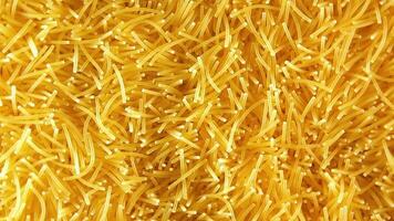 Background of Uncooked Noodles that Slowly Rotating Clockwise - Top View, Close-Up. Texture of Dry Vermicelli Turning Around. Raw Pasta with Low Key Light - Right Rotation video