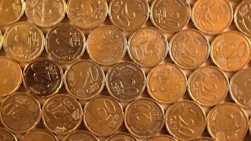 20 Euro Cent Coins, Rotating Money Background - Top View. Euro Money Currency. A Lot of Twenty Cent Cash. Golden Eurocents. Business, Finances and Money Saving Concept - Rotation Left video