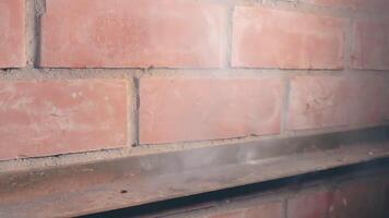 The Petard Was Placed on a Metal Surface by the Hand Than Explode Against a Brick Wall. Many Small Particles Flew in a Different Directions - Static Shot video